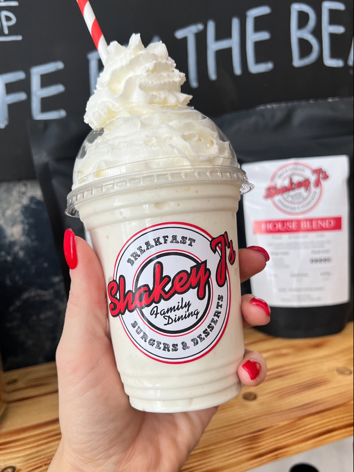 Shakey J's branded milkshake topped with whipped cream