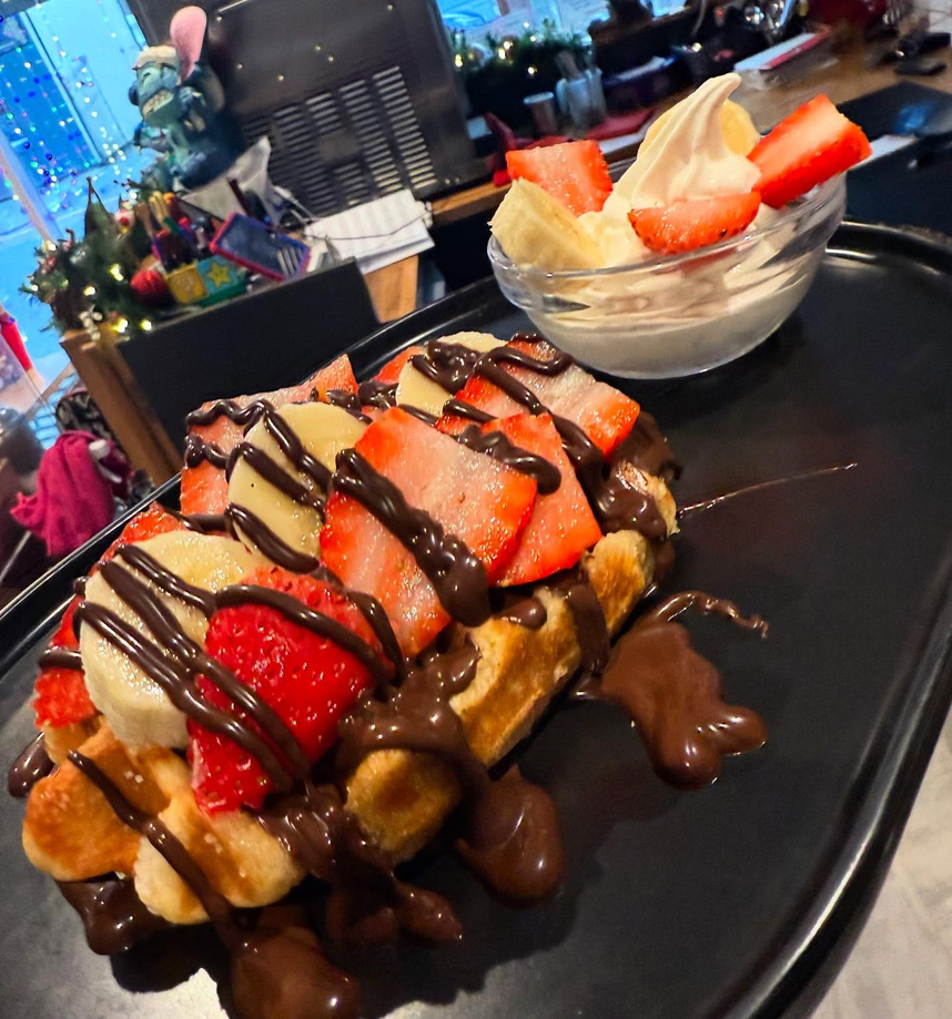 Loaded waffle with strawberries, banana and chocolate sauce